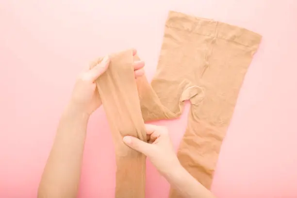 Close-up of neatly folded lingerie pieces stored in a drawer with dividers, highlighting the importance of proper storage techniques in preserving the shape and quality of lingerie